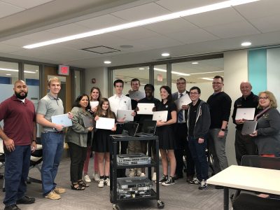 Joe Montgomery, Josh Coryea, and Jeremy Forstner from Outsell IT pictured with DeLaSalle students and staff