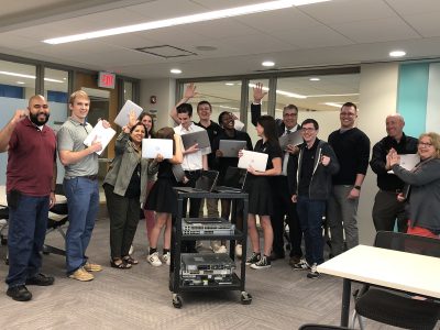 Joe Montgomery, Josh Coryea, and Jeremy Forstner from Outsell IT pictured with DeLaSalle students and staff