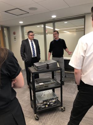 IT Infrastructure Manager, Jeremy Forstner, pictured right donating laptops to DeLaSalle high school