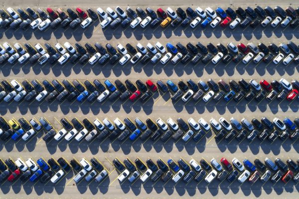 Rows of cars in a large parking lot, aerial view