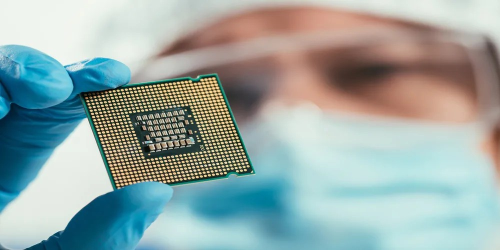 computer chip engineer holding a computer chip